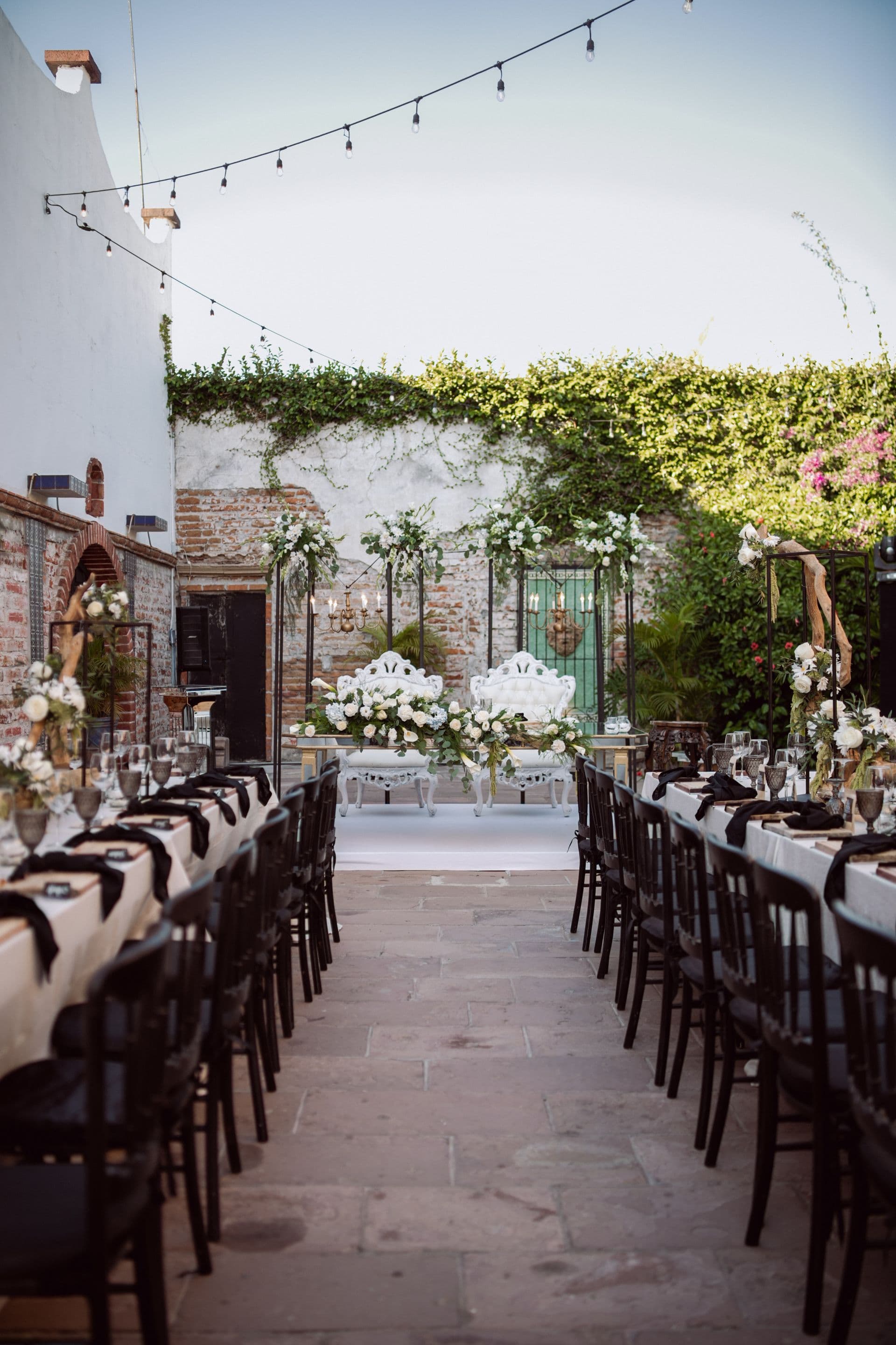 A courtyard wedding reception under string lights.